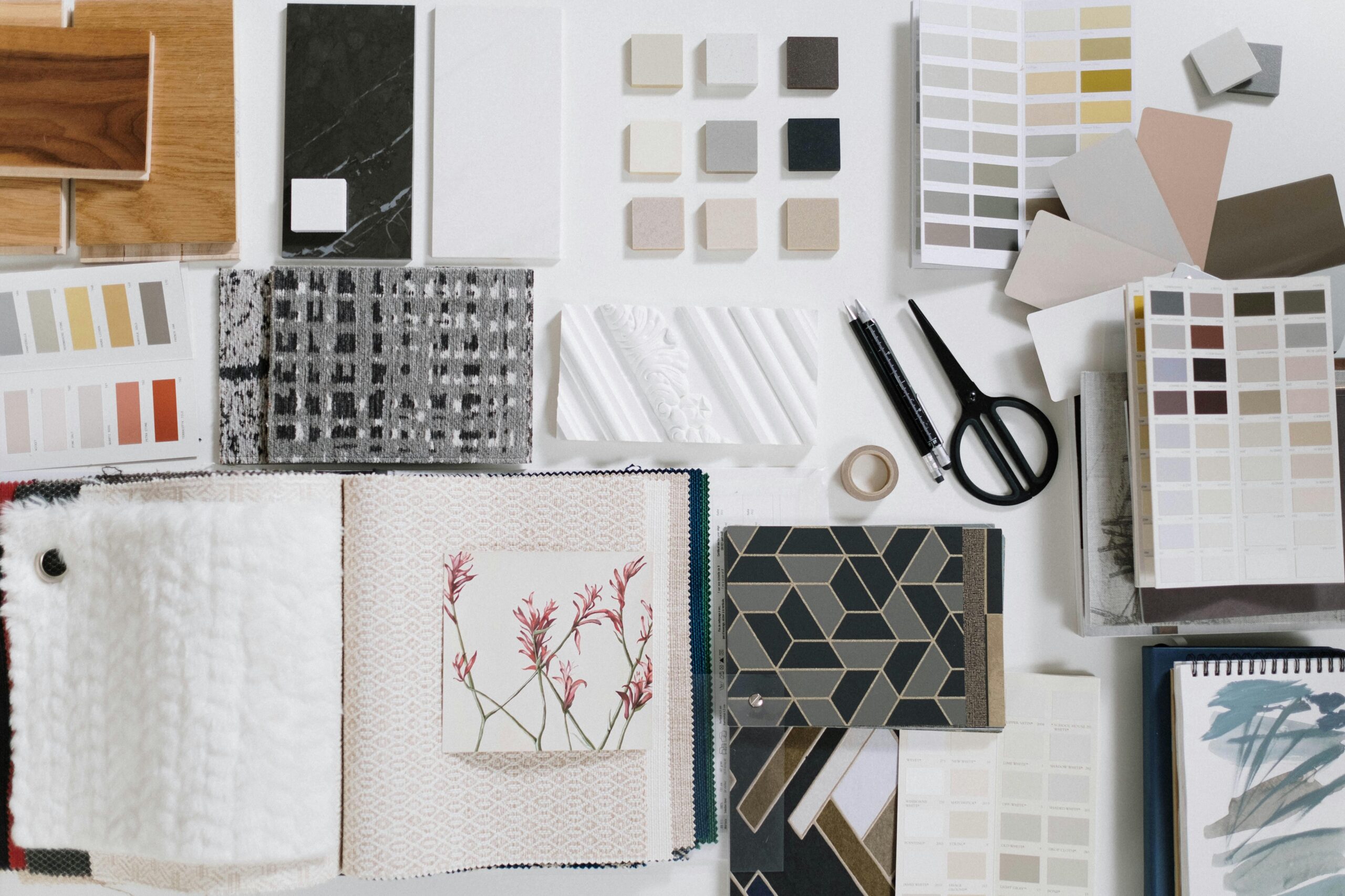 A flat lay of interior design samples showcasing textures and colors for creative inspiration.